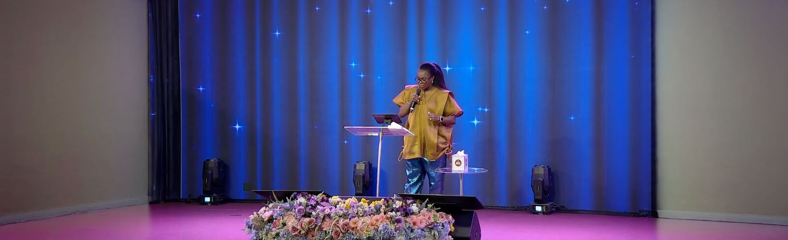 Toyin Adefemi speaking on stage